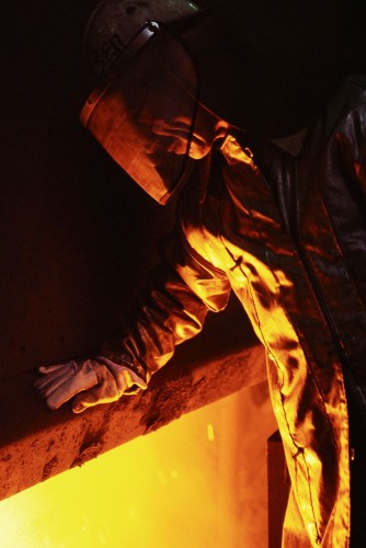Reportage industriel - Photo d'un homme au travail portant une combinaison ignifugé dans une aciérie, film inversible argentique. | Philippe DUREUIL Photographie